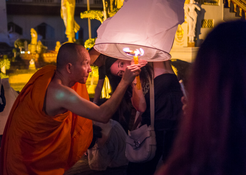 Loy Krathong Chiang Mai lantern festival - monk lighting up lantern